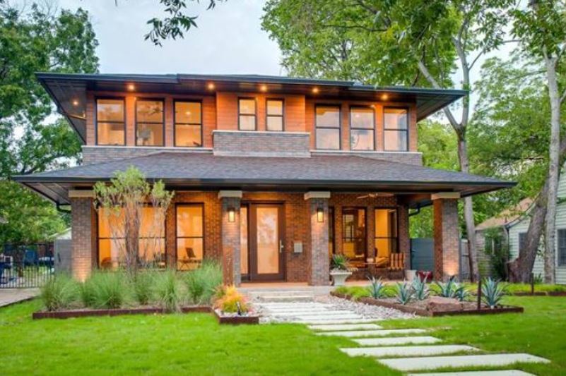 contemporary home exterior with warm window lighting in Plano, TX